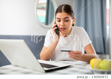 Young woman calling to bank customer service 136980672