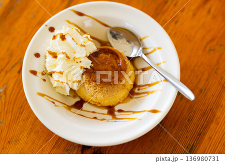 Delicate flan dessert is custard creamy delicacy made from milk, eggs and sugar. 136980731