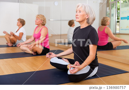 Mature women exercising lotus pose 136980757