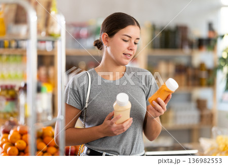 Woman choosing sauce in the store 136982553