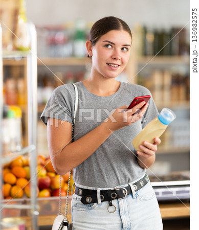 Young woman scanning qr code for mayonnaise 136982575