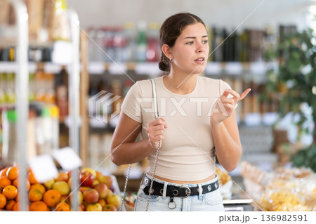 Young woman buyer forgot what she wanted to buy Young woman buyer forgot what she wanted to buy 136982591
