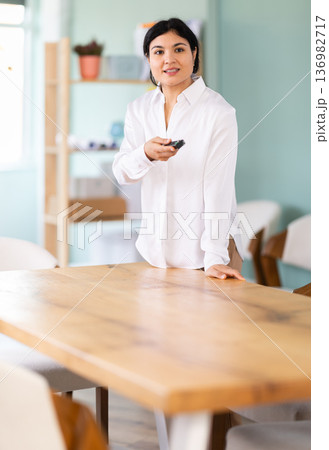 In lecture hall, woman with remote control In lecture hall, woman with remote control 136982717