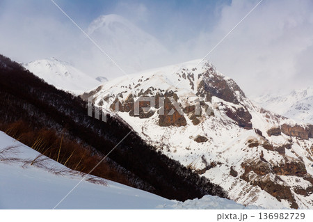 Mountain landscape of snow-capped Caucasus Range with Kazbek peak 136982729