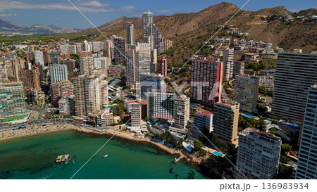Aerial view of Benidorm coastline with modern high rise buildings and turquoise Mediterranean sea Spain Aerial view of Benidorm coastline with modern high rise buildings and turquoise Mediterranean sea Spain 136983934