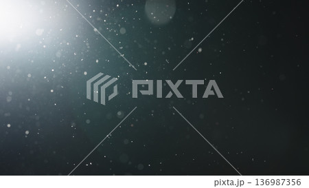 background of floating particles in air over black background and lens flare 136987356