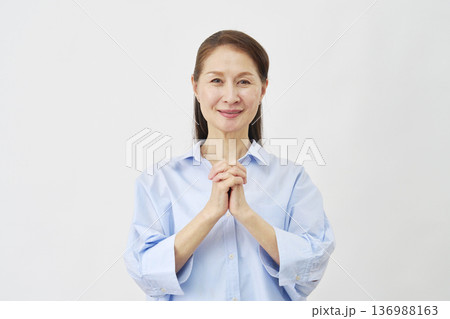 白背景で祈る高齢女性 136988163