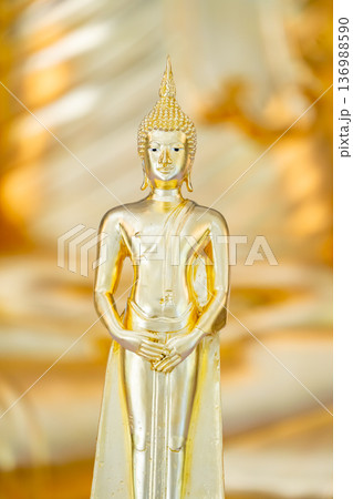 Golden Buddha statue serves as a symbol for the Lord Buddha. for adoration and reverence among Buddhists 136988590