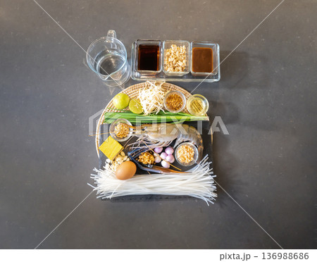 Flatlay Top Table of Pad Thai has a main ingredient such as noodle, shrimp, garlic chives, yellow tofu, chilli powder, shallot, fish sauce, palm sugar,and much more. 136988686
