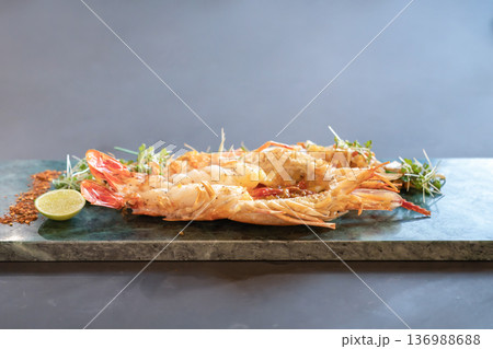Close up to the Lobster Pad Thai is ready to serve with fried noodle, tofu and other ingredients on a rectangular plate in studio light. 136988688