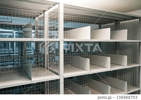 White shelves are lined up all over the area in a warehouse with a green floor. It also has an excellent security system. White shelves are lined up all over the area in a warehouse with a green floor. It also has an excellent security system. 136988703