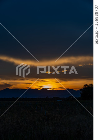 Senset moment view behind the mountain in the golden light from the sun. 136988707