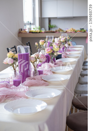 Decorated table with candles and flowers Decorated table with candles and flowers 136988739