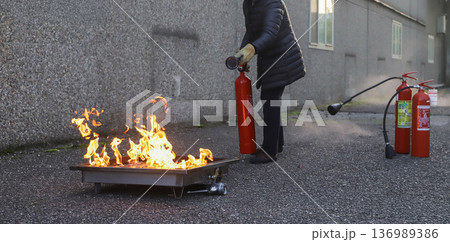 corporate safety - exercise during a firefighting course 136989386