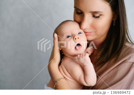 Mother Embracing Her Infant Baby Mother Embracing Her Infant Baby 136989472