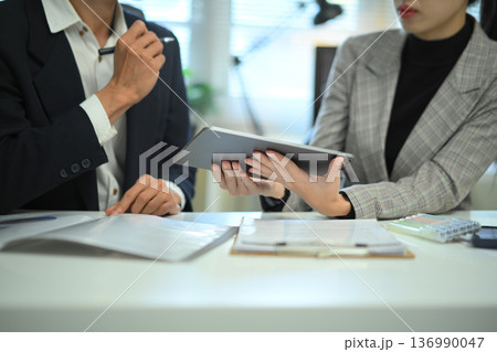 Teamwork meeting with tablet and business people in office workplace, closeup shot 136990047