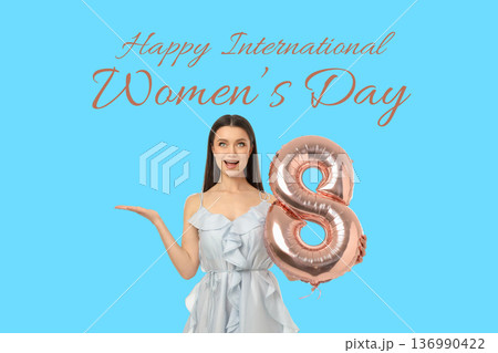 A young woman celebrates Women's Day holding a balloon 136990422