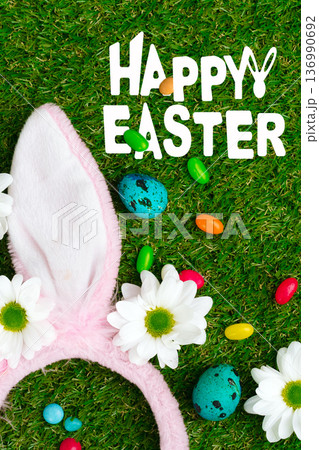 Celebrate Easter with colorful eggs and bunny ears on green grass 136990692