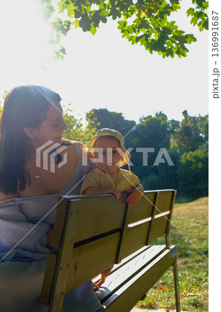 Mother and Child Enjoying a Sunny Day in the Park 136991687