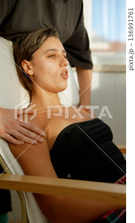 Woman relaxes during calming skin care session with gentle touches Woman relaxes during calming skin care session with gentle touches 136991761