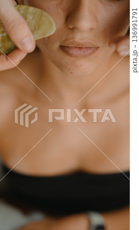 Closeup shot capturing tranquil face during calming massage session Closeup shot capturing tranquil face during calming massage session 136991791