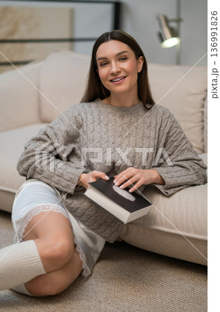Dark-haired young woman with a book in hands 136991826