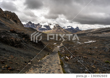 Stone trail leading to Pastoruri Glacier, Huaraz, Peru, amidst rugged mountains Stone trail leading to Pastoruri Glacier, Huaraz, Peru, amidst rugged mountains 136992669
