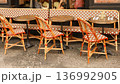 Parisian cafe terrace featuring classic rattan seating and bistro tables, ready for customers on a charming street 136992905