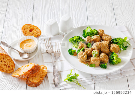 Belgian meatballs in creamy gravy with broccoli and bread Belgian meatballs in creamy gravy with broccoli and bread 136993234
