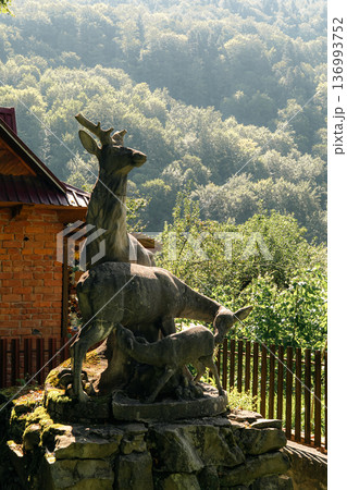 Stone Deer Sculpture in Mountain Forest Garden 136993752