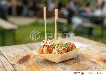 Takoyaki - traditional Japanese street food, outdoor snack with octopus Takoyaki fried balls 136993772