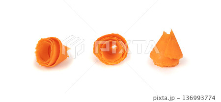 Thin carrot strips swirled in a rose flower shape isolated. Carrot slices for salad decoration Thin carrot strips swirled in a rose flower shape isolated. Carrot slices for salad decoration 136993774