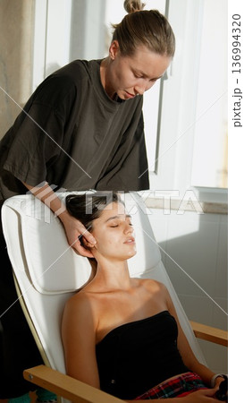Calming massage enhances skin with soothing sunlight ambiance 136994320
