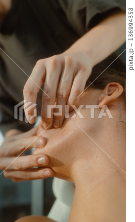 Practitioner applies delicate touch to realign jaw joint Practitioner applies delicate touch to realign jaw joint 136994358
