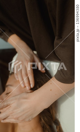Closeup of massage therapist executing lymphatic drainage technique 136994380