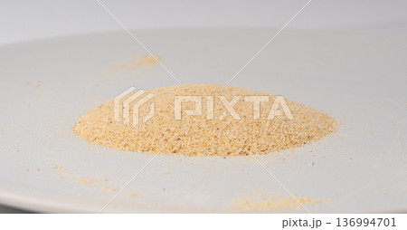 Garlic powder pile isolated, dried granulated chopped crushed garlic on white background 136994701