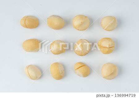Macadamia nuts isolated. Natural raw peeled macadamia seeds and shells 136994719
