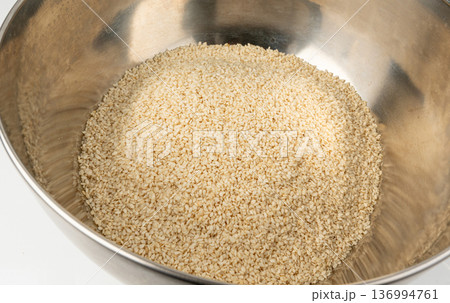 Sesame seeds pile closeup, white small benne grains. Sesamum indicum fruits 136994761