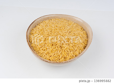 Raw orzo pasta, risoni or kritharaki pile 136995882