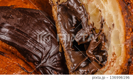 Chocolate filled croissant close up with creamy texture 136996196