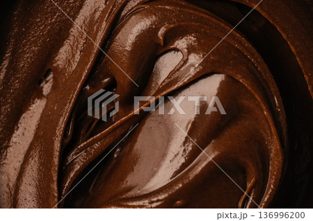 Dark chocolate cream swirl macro background Dark chocolate cream swirl macro background 136996200