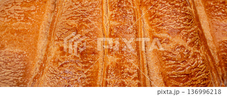 Golden flaky croissant crust texture extreme macro 136996218