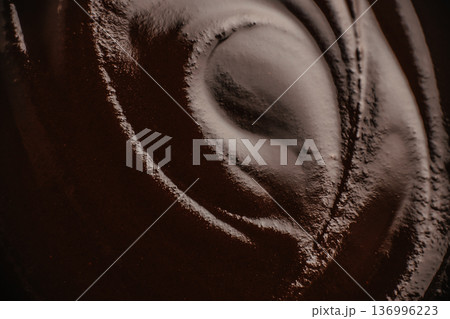 Dark chocolate swirl texture with smooth cocoa surface Dark chocolate swirl texture with smooth cocoa surface 136996223