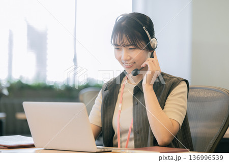 インカムで話すオペレーターの若い女性 インカムで話すオペレーターの若い女性 136996539