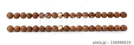 Macadamia nuts isolated. Natural raw peeled macadamia seeds and shells Macadamia nuts isolated. Natural raw peeled macadamia seeds and shells 136996619