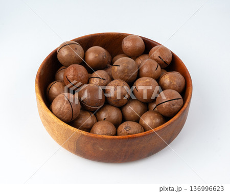 Macadamia nuts isolated. Natural raw peeled macadamia seeds and shells Macadamia nuts isolated. Natural raw peeled macadamia seeds and shells 136996623