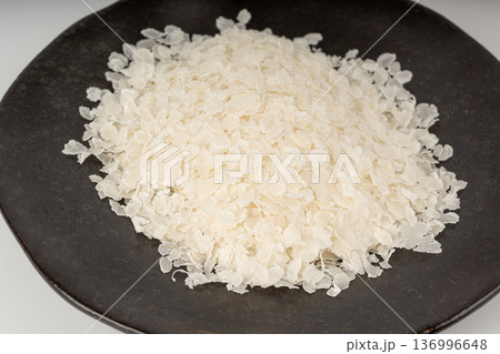 Raw flattened rice. Dry rice flakes or poha, Indian breakfast food Raw flattened rice. Dry rice flakes or poha, Indian breakfast food 136996648