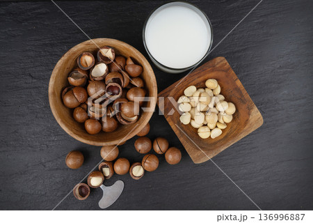 Macadamia nuts. Natural raw peeled macadamia seeds and shells 136996887