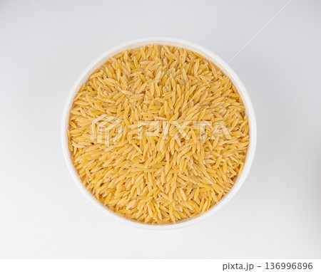 Raw orzo pasta, risoni or kritharaki pile 136996896