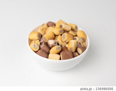 Filled dog biscuits, crackers isolated, soft crunchy pet treats pile, flavored small canine cookie Filled dog biscuits, crackers isolated, soft crunchy pet treats pile, flavored small canine cookie 136996898